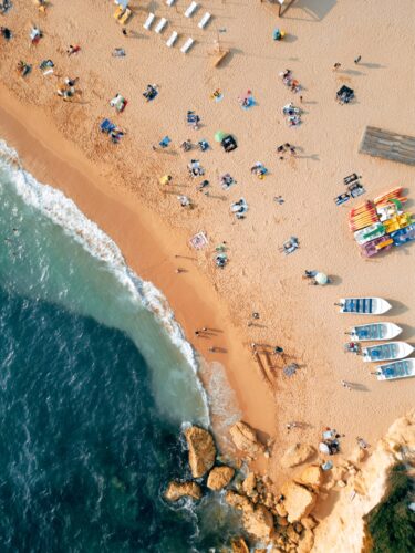 An aerial view of a beach with a lot of people